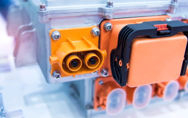 Orange high-voltage e-mobility connector showcasing Clariant's Nylostab S-EED for color strength and heat stability.