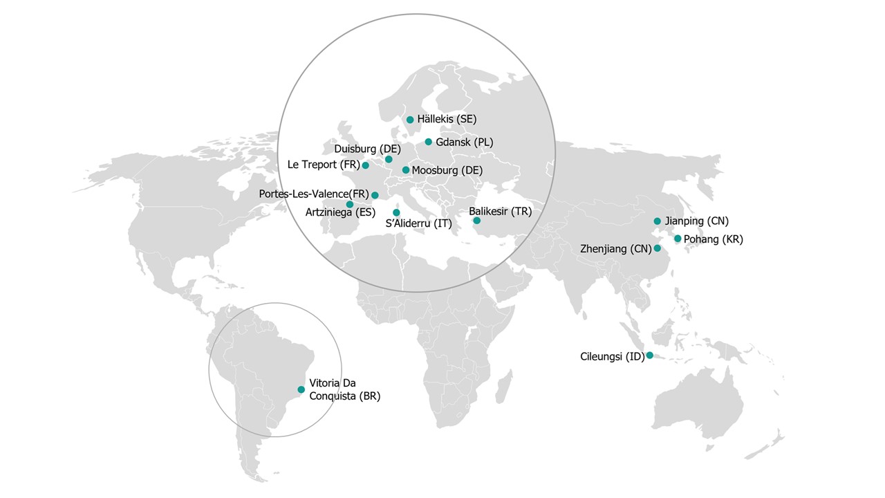 The image is a world map showing several marked locations, with two highlighted circular regions:

- **Europe cluster**: Hällekis (SE), Gdansk (PL), Duisburg (DE), Le Treport (FR), Portes-Les-Valence (FR), Artziniega (ES), S’Aliderru (IT), Moosburg (DE), and Balikesir (TR)
- **South America cluster**: Vitoria Da Conquista (BR)
- **Asia locations**: Jianping (CN), Zhenjiang (CN), Pohang (KR), and Cileungsi (ID)

If you want, I can also extract the labels into a clean list or describe the map in more detail.